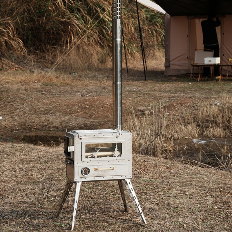 Portable stove on a stand in an outdoor setting with a tent in the background