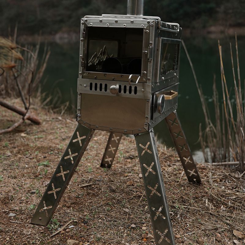 Metallic outdoor stove on a tripod in a natural setting