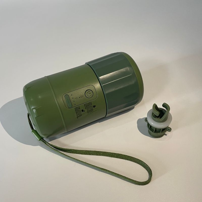 Green portable speaker with a strap on a white background