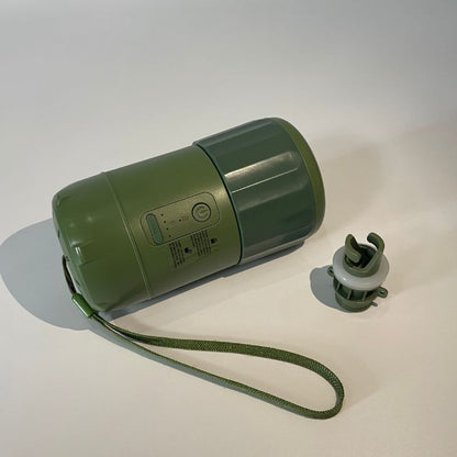 Green portable speaker with a strap on a white background