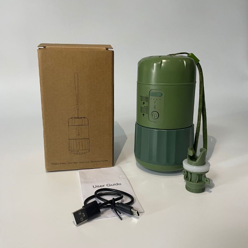 Green water filter with packaging, user guide, and USB cable on a white background