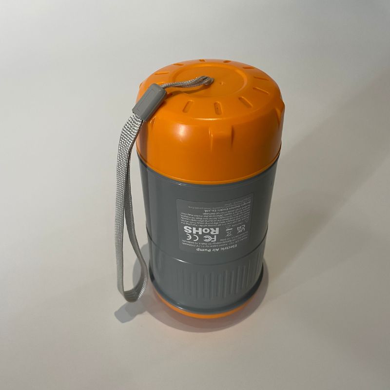 Gray container with orange lid and strap on a white background