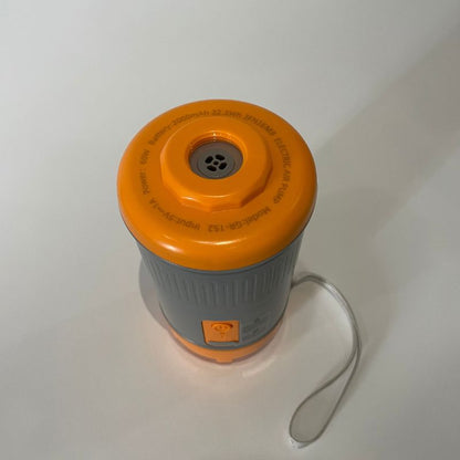 Orange and gray camping stove on a white background