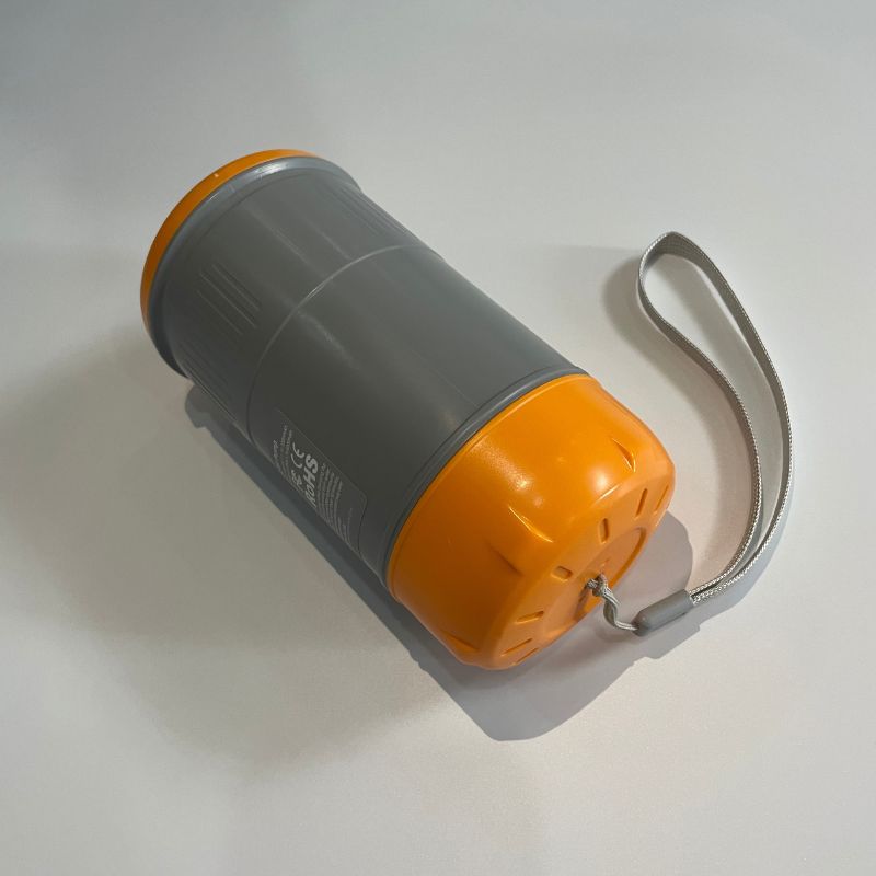 Gray and orange container with a strap on a light gray background
