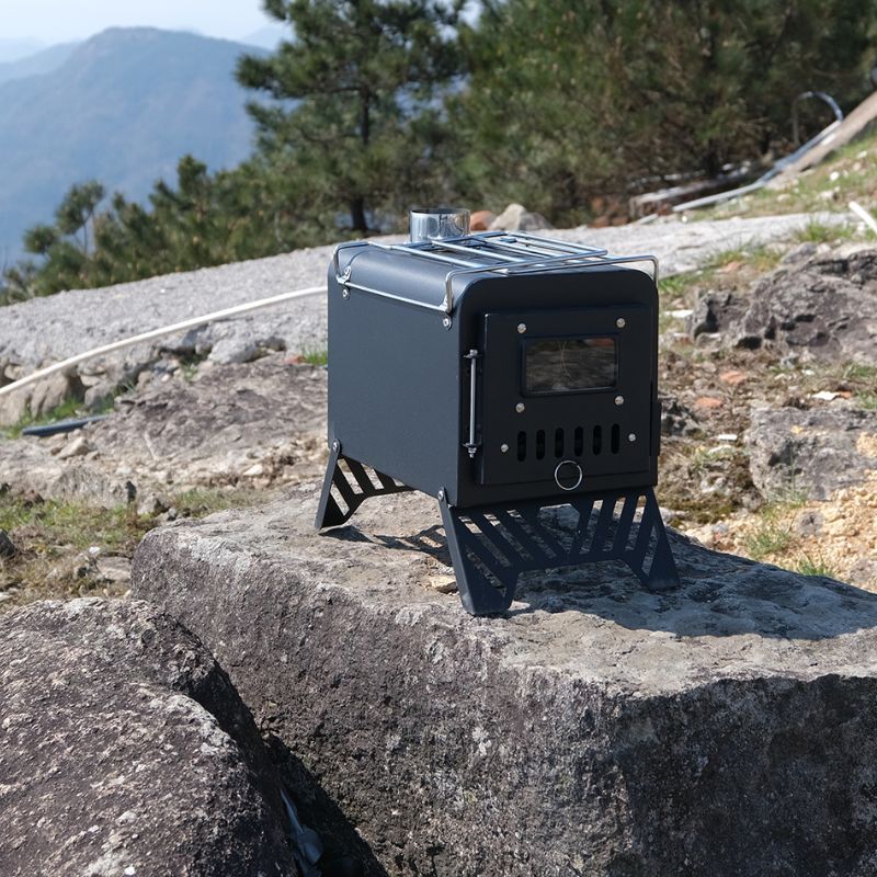 Portable stove on a rock with a mountainous background