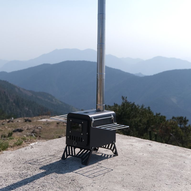 Portable stove on a mountain top with a scenic view of mountains in the background
