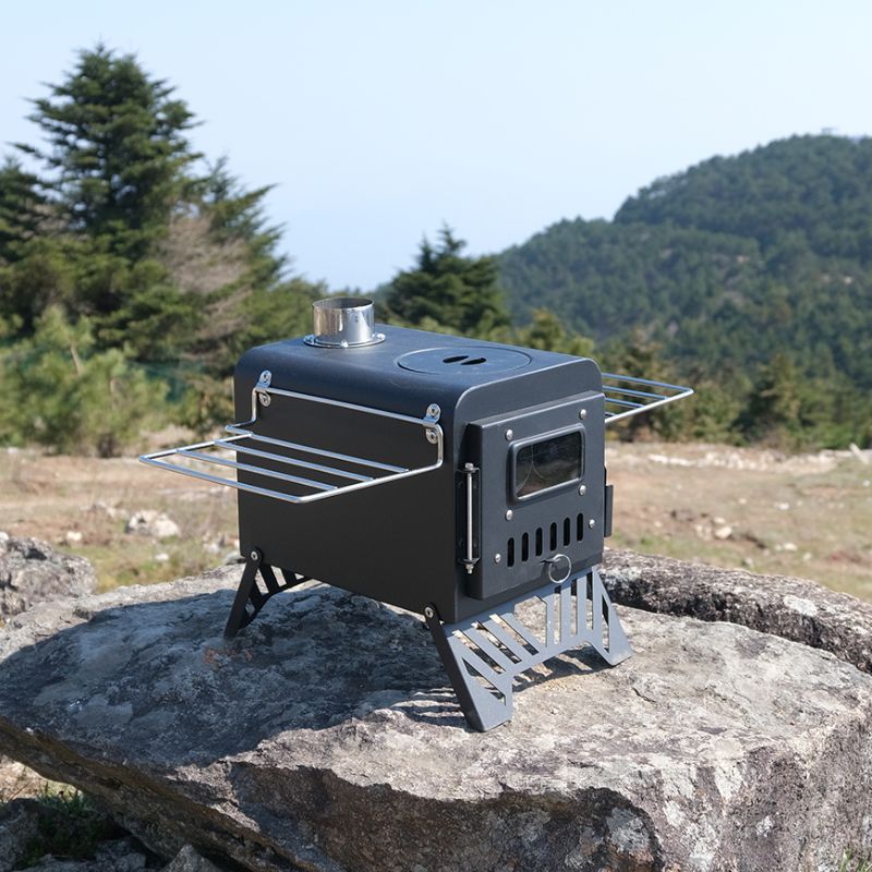 Portable wood stove on a rock with a mountainous background
