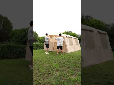 Beige 10-12 person extra large inflatable tent quick setup video with two people inflating on grass field
