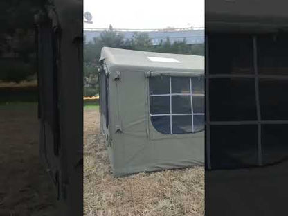 Green TC cotton inflatable glamping tent set up outdoors in a grassy field with natural background