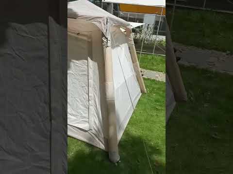 Beige lightweight inflatable camping tent quick setup video on grass field with double doors and rain cover