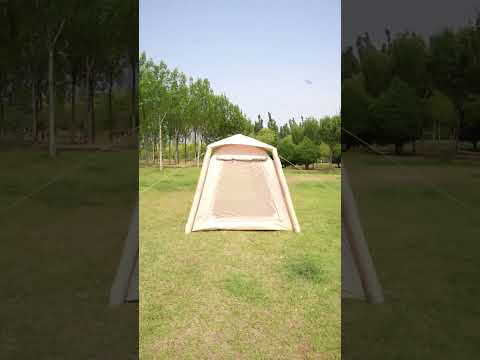 Beige 6-person inflatable camping tent set up on grass under trees for family camping and glamping
